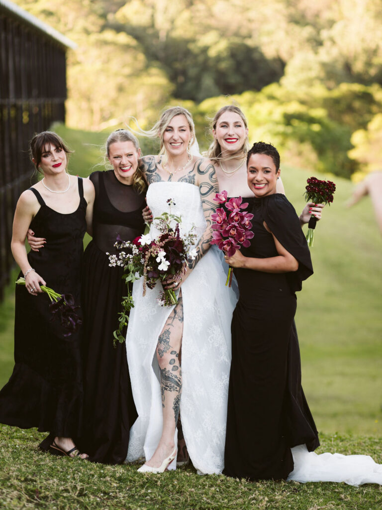Bride with four bridesmaids in black holding individual bouquets of dark calla lilies, cymbidium orchids and mixed posies at Bundanon Trust, Shoalhaven wedding