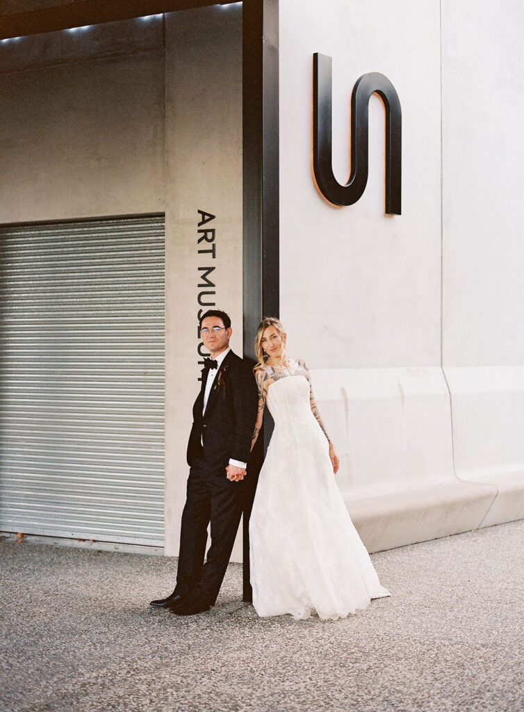 Bride and groom holding hands at Bundanon Art Museum entrance, Shoalhaven Southern Highlands – wedding flowers by Krysta Smith Floral Artistry